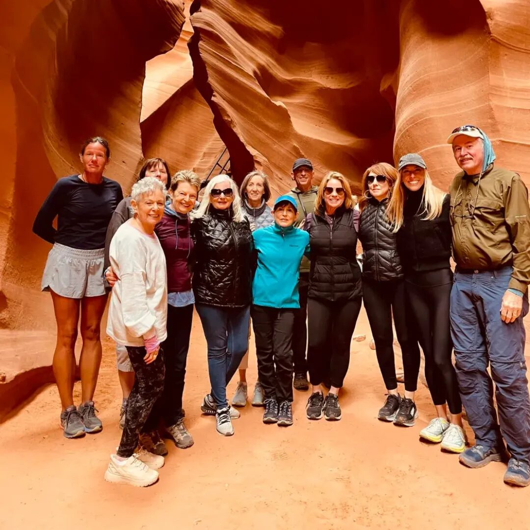 Group hiking through the sandstone curves of Antelope Canyon