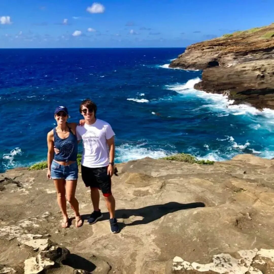 Tanya and her husband on a rocky ocean overlook
