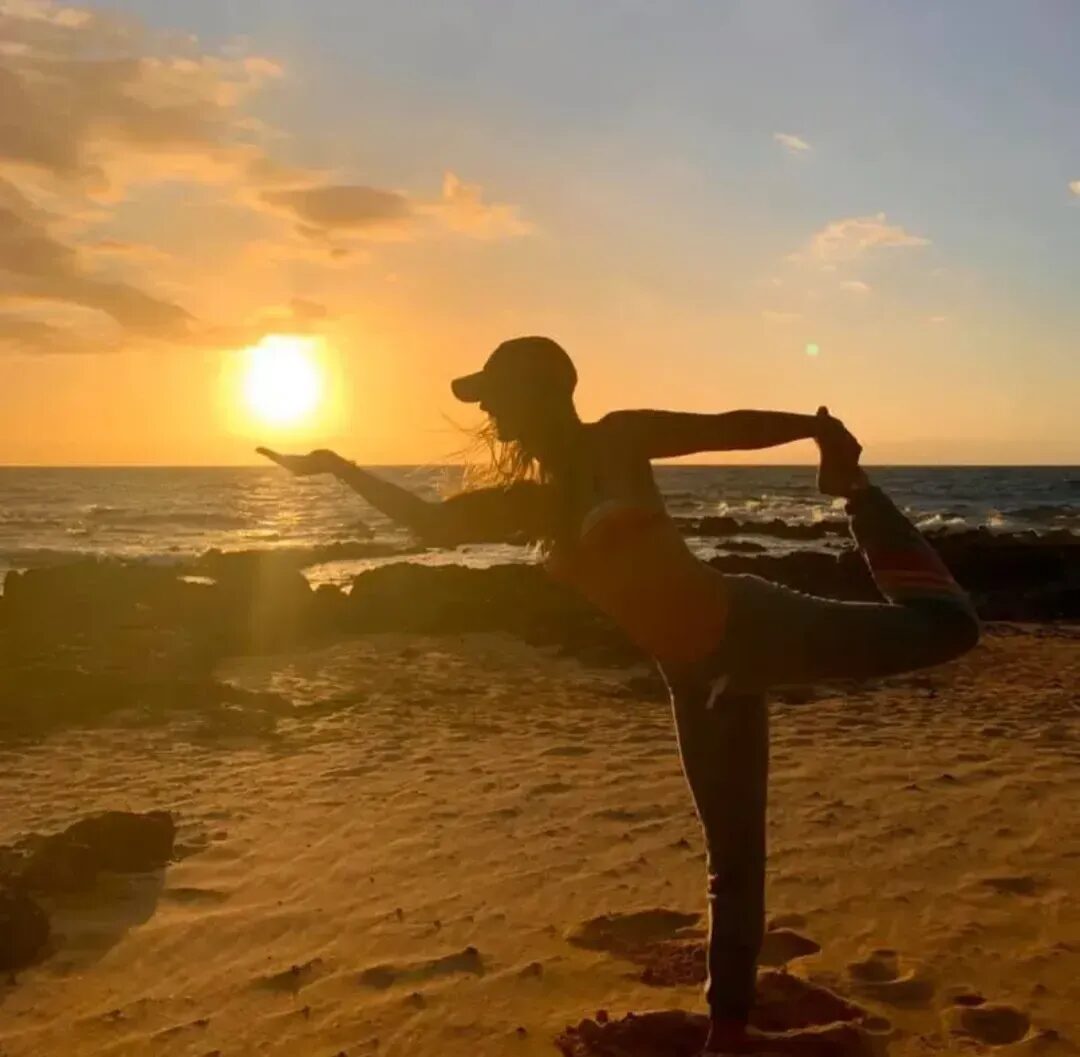 Tanya Ford in dancer pose, silhouetted against an ocean sunset